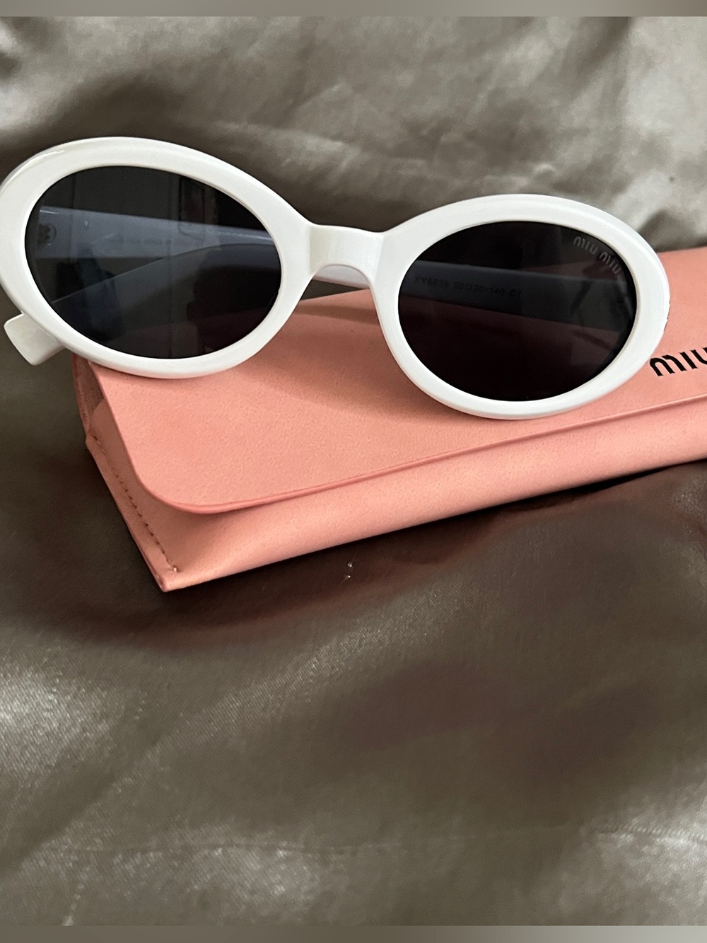 Miu Miu White Oval Sunglasses with Dark Lenses